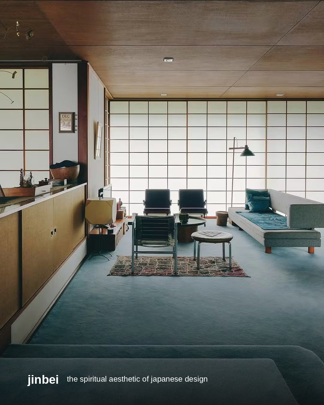 A minimalist Japanese living room with tatami floor, shoji paper screens and wood-panelled ceiling, styled with the jinbei wordmark and the article title, 'the spiritual aesthetic of japanese design.'